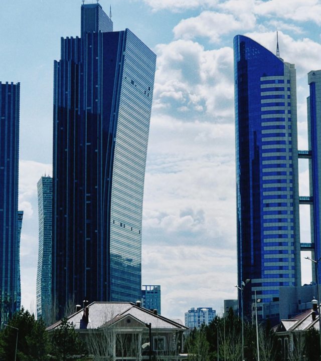 Striking view of modern skyscrapers under a blue sky in Astana, Kazakhstan.